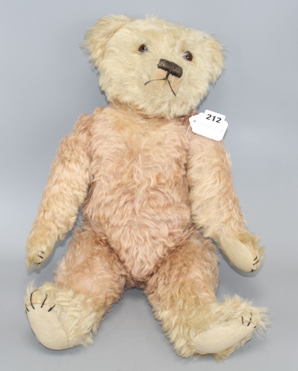 A c.1930s bear, possibly Farnell, 22in., faded pink mohair, original paw pads, good condition except faded head, 22in.